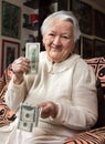 Old woman holding dollar cash money Royalty Free Stock Photo