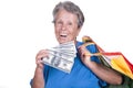 Old woman holding dollars and bags Royalty Free Stock Photo