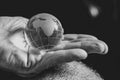 old woman holding a glass globe in her hands, black and white photo, the world is in hands Royalty Free Stock Photo