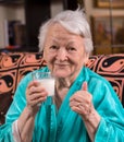 Old woman holding a glass milk Royalty Free Stock Photo