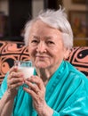 Old woman holding a glass milk Royalty Free Stock Photo