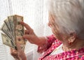 Old woman holding money in hands Royalty Free Stock Photo