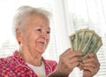 Old woman holding money in hands Royalty Free Stock Photo