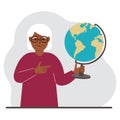 A old woman holds a globe in his hand and points his finger at it. The concept of education, teacher, world conquest Royalty Free Stock Photo