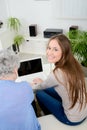 Old woman at home with cheerful young girl spending time together with laptop computer Royalty Free Stock Photo