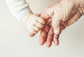 An old woman and a kid holding hands together Royalty Free Stock Photo