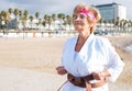 Old woman in kimono on beach