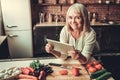 Old woman in kitchen Royalty Free Stock Photo