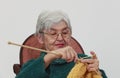 Old woman knitting