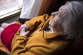 Old woman looking in a window Royalty Free Stock Photo