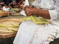 Old woman making bamboo baskets