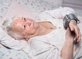 Old woman measures arterial pressure Royalty Free Stock Photo