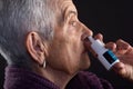 Old woman with nasal spray
