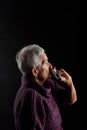 Old woman with nasal spray Royalty Free Stock Photo