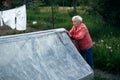 An old woman near her village house. Nature. Royalty Free Stock Photo