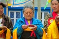 Old woman with orange scarf at celebration ceremony in Nepal