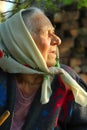 Old woman over 90 years old enjoying sunset, side view