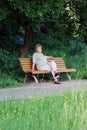 Old woman on a park bench thinking Royalty Free Stock Photo