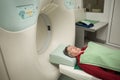 Old woman patient at computerized axial tomography (CAT) scan.Examining cancer patient with CT.Tumor detection