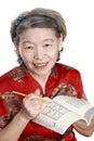 Old woman play sudoku