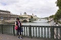 Old woman posing for take photo on bridge crossover Seine river Royalty Free Stock Photo