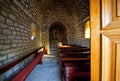 Old woman praying in empty village church Mediterranean