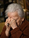 Old woman praying and holding silver rosary Royalty Free Stock Photo