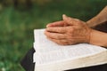 Old woman praying for hope or reading holy bible Royalty Free Stock Photo