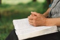 Old woman praying for hope or reading holy bible Royalty Free Stock Photo