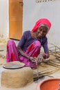 Old woman preparing a fire for making chapati bread