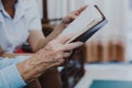 Old woman reading bible together with young woman in home Royalty Free Stock Photo