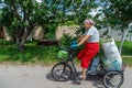 An old woman rides a bicycle. Selection focus.