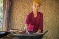 Old woman roasting luwak coffee
