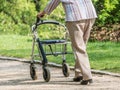 Old woman with rollator in the city park