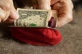 old woman& x27;s hands take out a dollar bill from a soft red wallet, money in a wallet Royalty Free Stock Photo