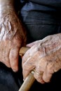 Old woman`s hands holding a cane Royalty Free Stock Photo