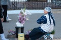 Old woman selling flowers in the street in Kazan,Russia