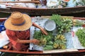 Old woman selling fruits and vegetables in a traditional floating market Royalty Free Stock Photo