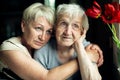 An old woman sits thoughtfully with an adult daughterÃÅ½ Royalty Free Stock Photo