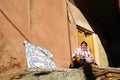 A old woman sitting in front of door at Abyaneh village, Isfahan, Iran