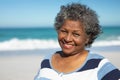 Old woman smiling at the beach Royalty Free Stock Photo