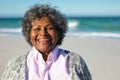 Old woman smiling at the beach Royalty Free Stock Photo