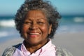 Old woman smiling at the beach Royalty Free Stock Photo