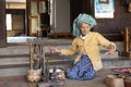 Old woman is spinning cotton threads, Myanmar