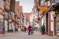 An old woman stand on the street of Celle town, Germany