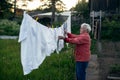 An old woman stands near her village house. Help. Royalty Free Stock Photo