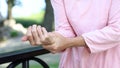 Old woman stretching numb arm, weakness of muscles in senior age, arthritis Royalty Free Stock Photo