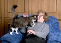 The old woman stroke a cat