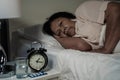 Old woman suffering from insomnia is trying to sleep in bed Royalty Free Stock Photo