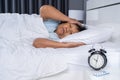 Old woman suffering from insomnia is trying to sleep in bed Royalty Free Stock Photo